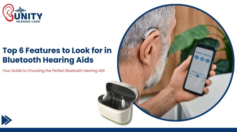 Audiologist fitting a hearing aid on an elderly woman